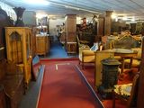 a room filled with antique furniture and antiques on display