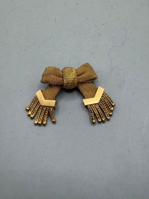 an image of a pair of gold toned earrings with tassels