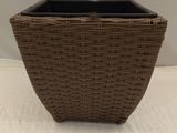 a wicker planter that is sitting on a table