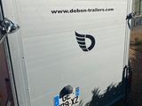 an image of a white trailer parked in a lot