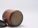 a small wooden container with a lid and a black lid