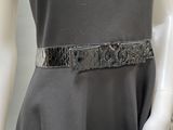 a mannequin wearing a dress and a belt on a mannequin mannequin
