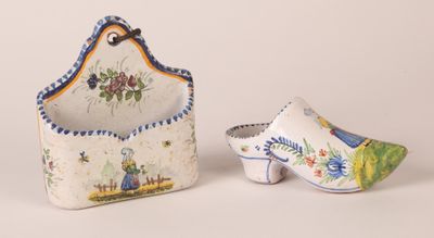 pair of ceramic shoes and a purse on a white surface