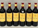 six bottles of red wine lined up in a row on a table
