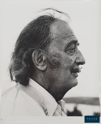 an old black and white photo of a man with long hair