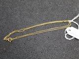 a close up of a gold chain with a key on it