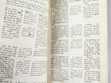 an old open book with writing on it sitting on top of a table
