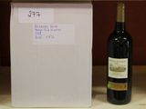 a bottle of wine sitting next to a box on a table
