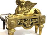 a gold statue of a winged lion on a bench
