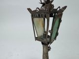 a lamp post with a bird on top of it in the snow