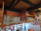 many glasses on the shelves in the room