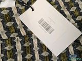 a label on a piece of fabric with a price tag attached to it