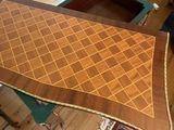 a table that has a wooden table top with a pattern on it