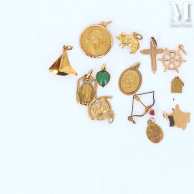 many different types of gold jewelry on a white surface