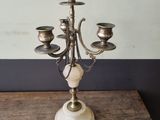 a silver candelab with five candles on a wooden table