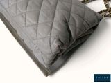 grey quilted purse with gold chain strap on white background