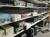 a room with a lot of electronics on the shelves
