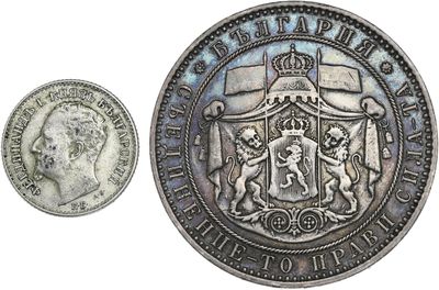 an old silver coin with a crown on top of it next to a coin with a crown on it