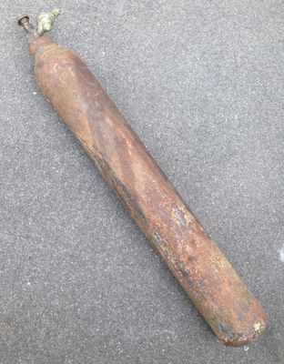 an old baseball bat laying on top of a cement floor
