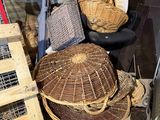 a pile of wicker baskets and other items on the ground