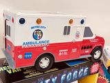 a toy ambulance truck sitting on top of a box