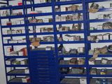 a blue shelving with lots of items on it in a room