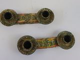 pair of antique brass candlesticks on a white background