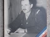 black and white photograph of a man in uniform sitting at a desk