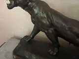 a statue of a lion on a pedestal in a room