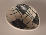 a white bowl with a black and white design on it