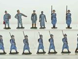 many figurines of men in blue uniforms on display