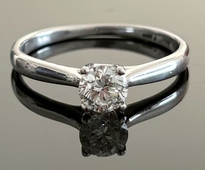 an image of a diamond ring on a reflective surface