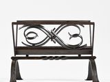 an iron bench with a decorative design on it against a white background