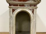 an image of a small dog house made of marble on a wooden floor