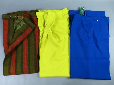 three pairs of men ' s pants, one blue, one yellow and one red