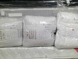 three pillows and a pillow on the top of a mattress