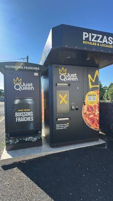 a black and white photo of a vending machine with a pizza on it