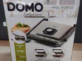 boxed box of a multi grill sitting on a wooden table