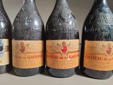 four bottles of wine are lined up on a table