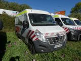 many ambulances parked in a row on the side of the road