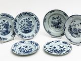 six blue and white plates with flowers and birds on them