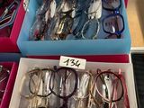several pairs of eyeglasses are in a box on a table