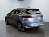 the back of a silver car is parked in a garage