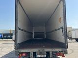 the back of a white truck with a flat bed parked in a parking lot