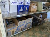 many boxes and containers on a metal shelf in a kitchen