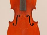 an old violin sitting on top of a white surface
