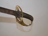 a close up of a sword with a ring on it