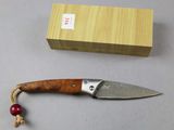 a knife that is laying on a table next to a box