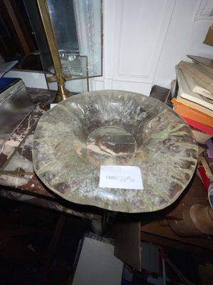 un saladier en verre posé sur une table, à côté d'une pile de livres