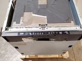 a broken dishwasher sitting on top of a wooden pallet